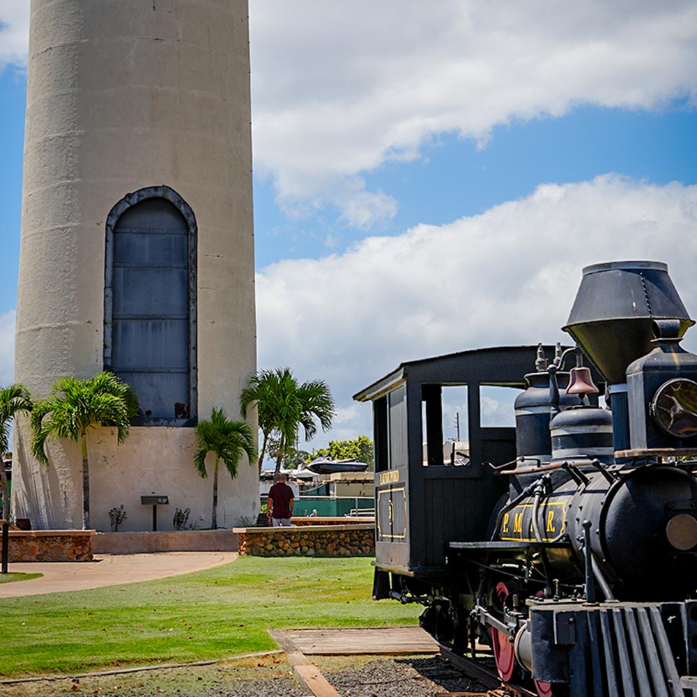 image of historic smokestack and trains in Lahaina.